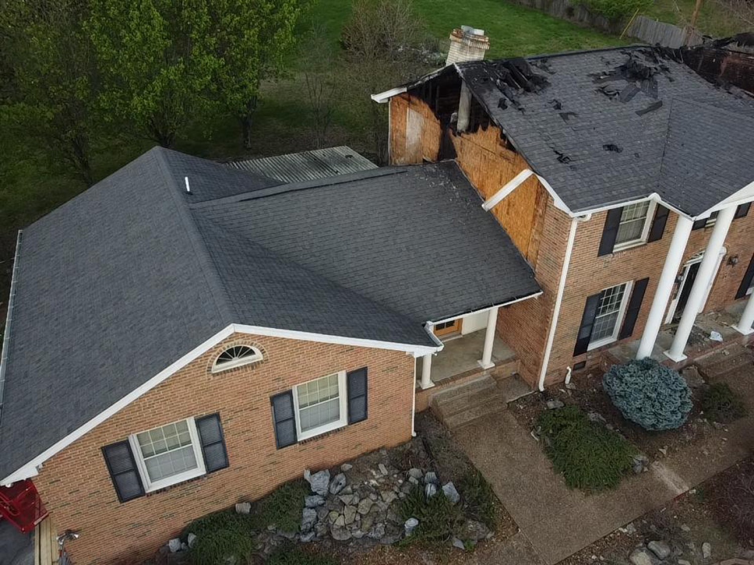 Fire-damaged roof before temporary roofing film