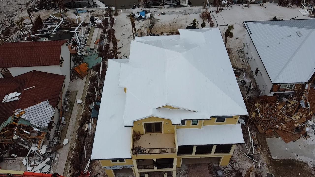 Same hurricane-damaged roof sealed under stretch roofing film
